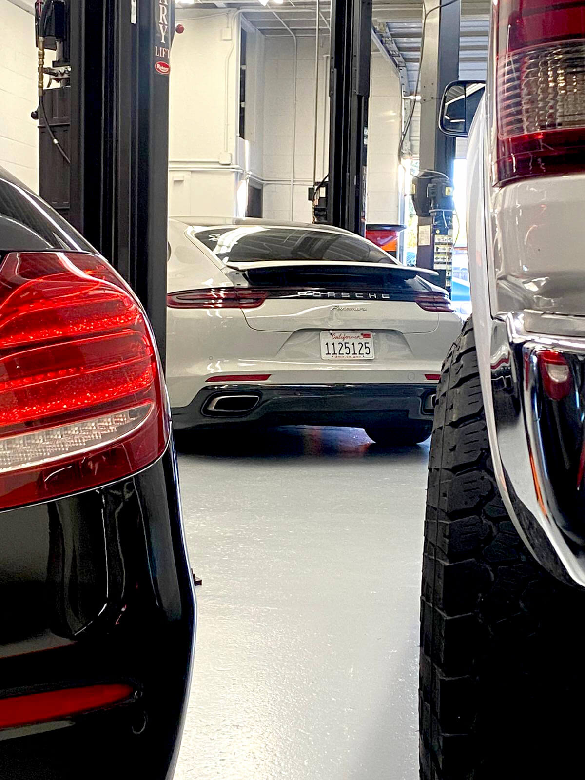 cars in a repair shop Porsche